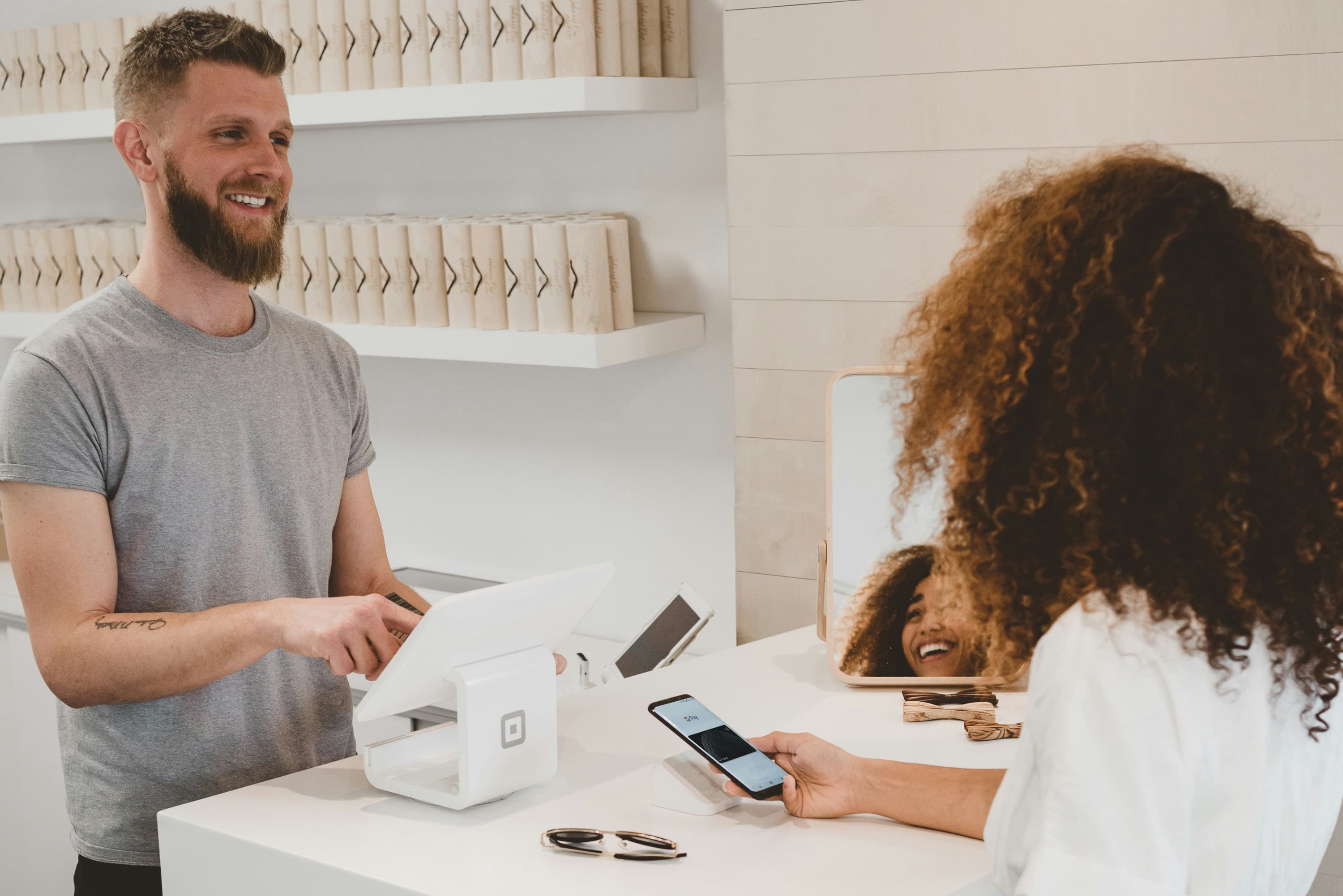 Commerçant qui remet un ticket avec un QR code à un client satisfait